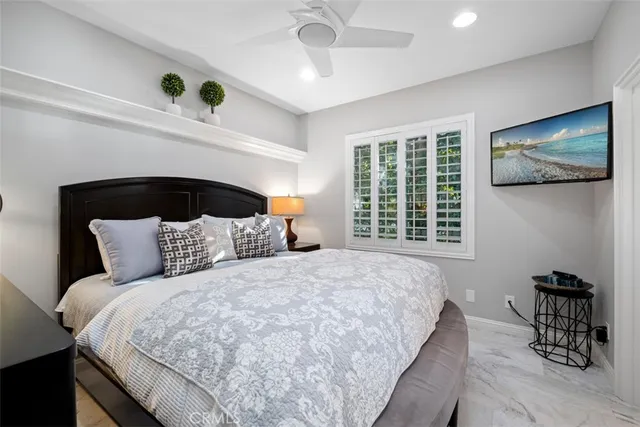 a large bed sitting in a bedroom next to a window