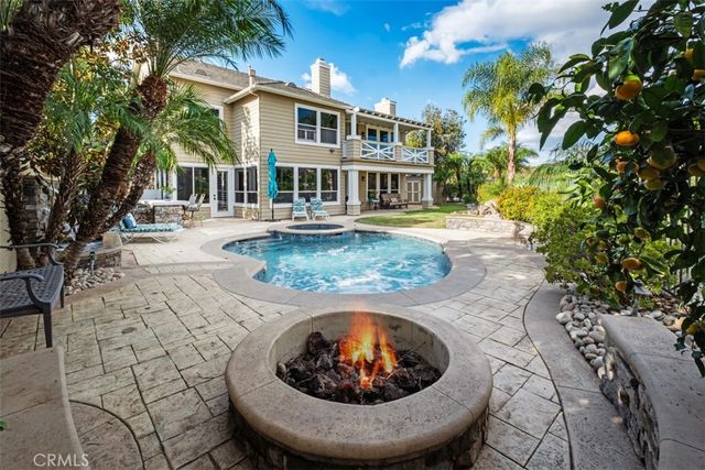 a view of a house with pool and trees