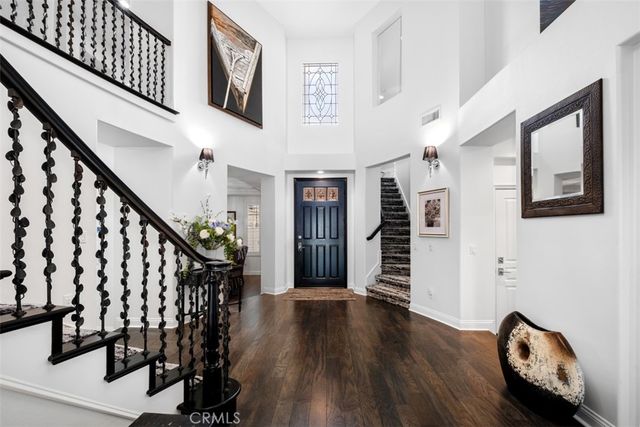 a view of a hallway with wooden floor and stairs