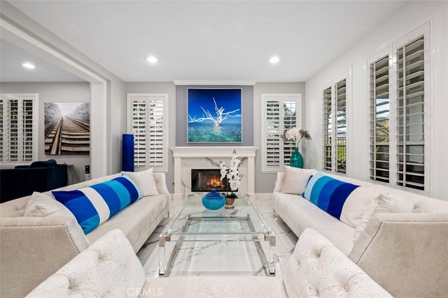 a living room with furniture fireplace and a large window