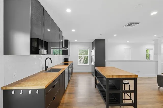 a kitchen with kitchen island a sink table and chairs