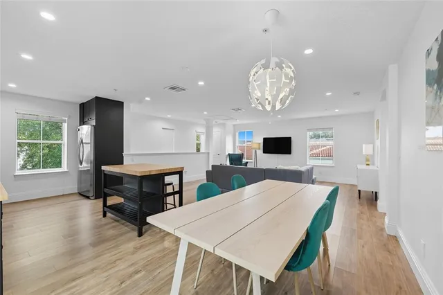 a view of a dining room with furniture window and wooden floor