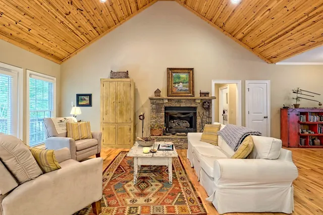 a living room with furniture a fireplace and a large window