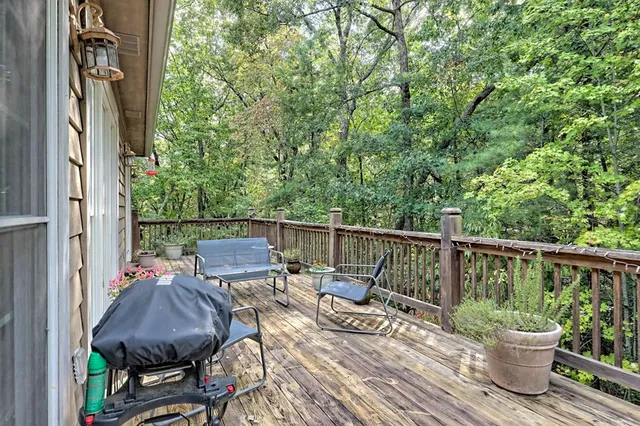a view of balcony with furniture and potted plants