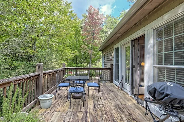 a view of a deck with two chair and wooden floor