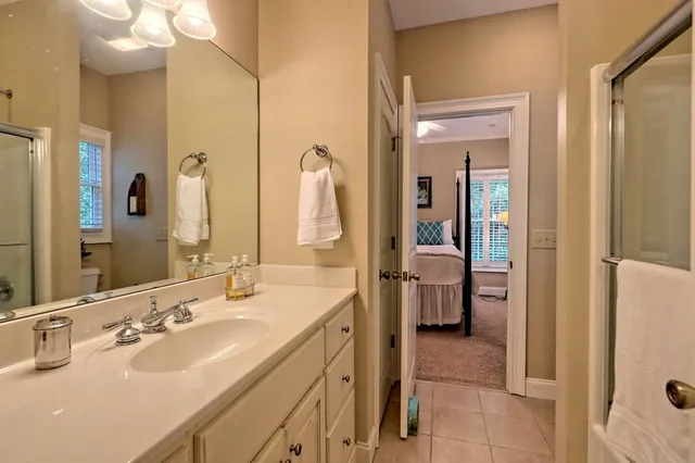 a en suite bathroom with a double vanity sink a mirror and shower