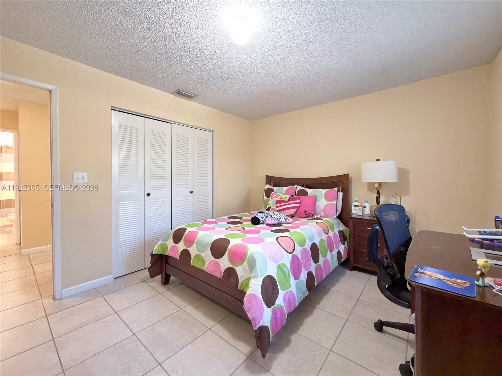 14911 Southwest 80th Street, Unit 221 Miami, FL 33193 - Photo 19 of 31 a bedroom with a bed and window
