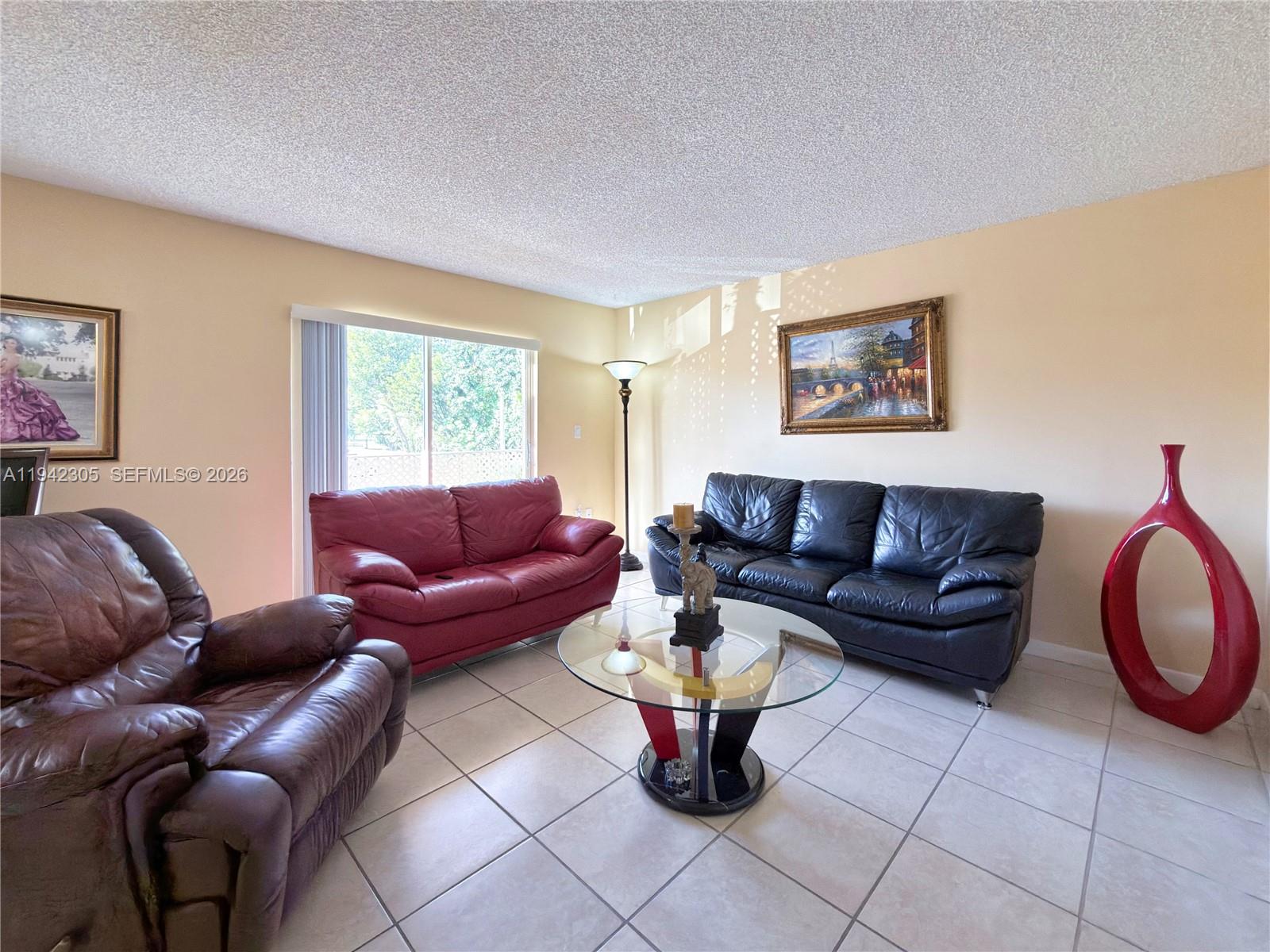 14911 Southwest 80th Street, Unit 221 Miami, FL 33193 - Photo 26 of 31 a living room with furniture and a window