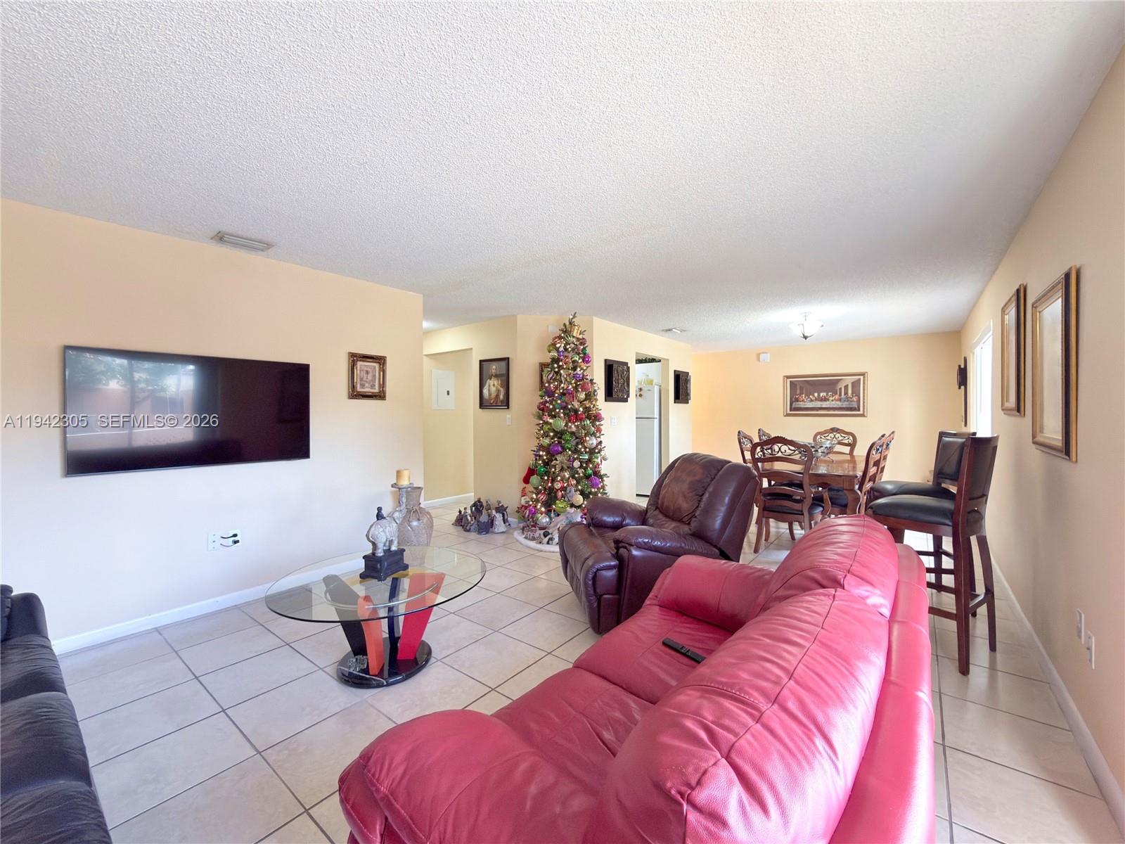 14911 Southwest 80th Street, Unit 221 Miami, FL 33193 - Photo 28 of 31 a living room with furniture and a flat screen tv