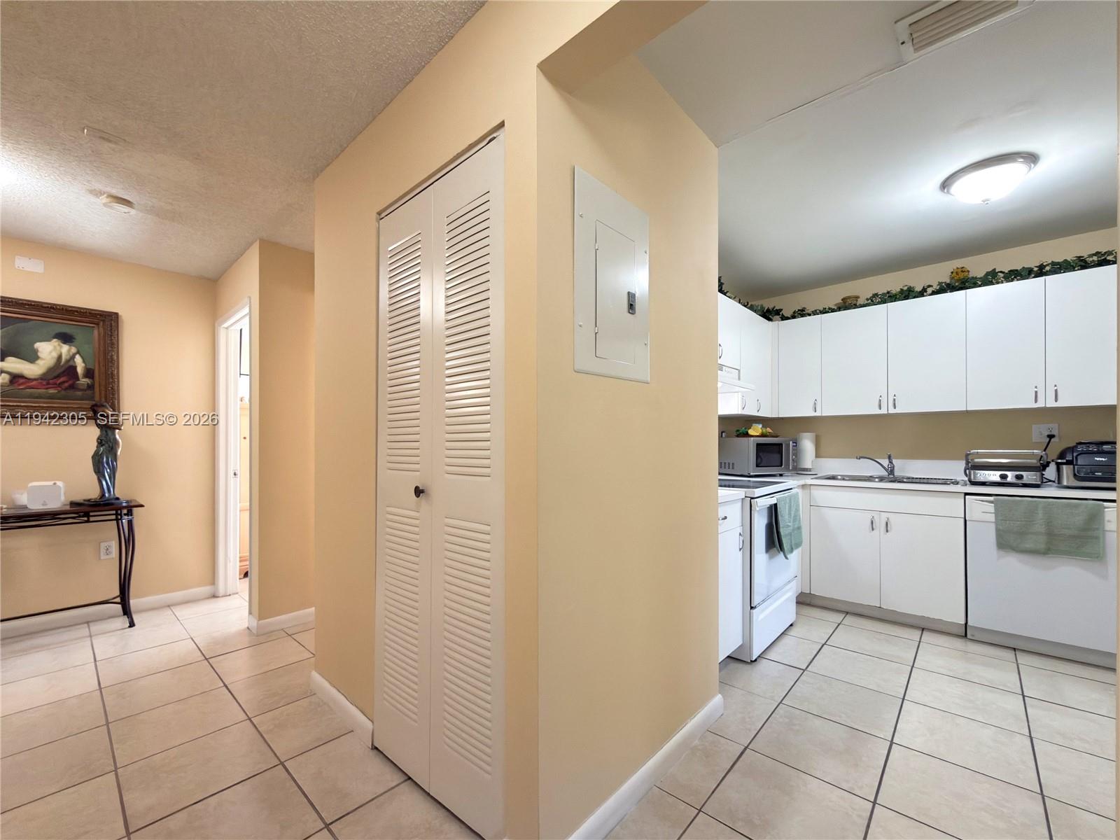 14911 Southwest 80th Street, Unit 221 Miami, FL 33193 - Photo 3 of 31 a kitchen with a cabinets and appliances