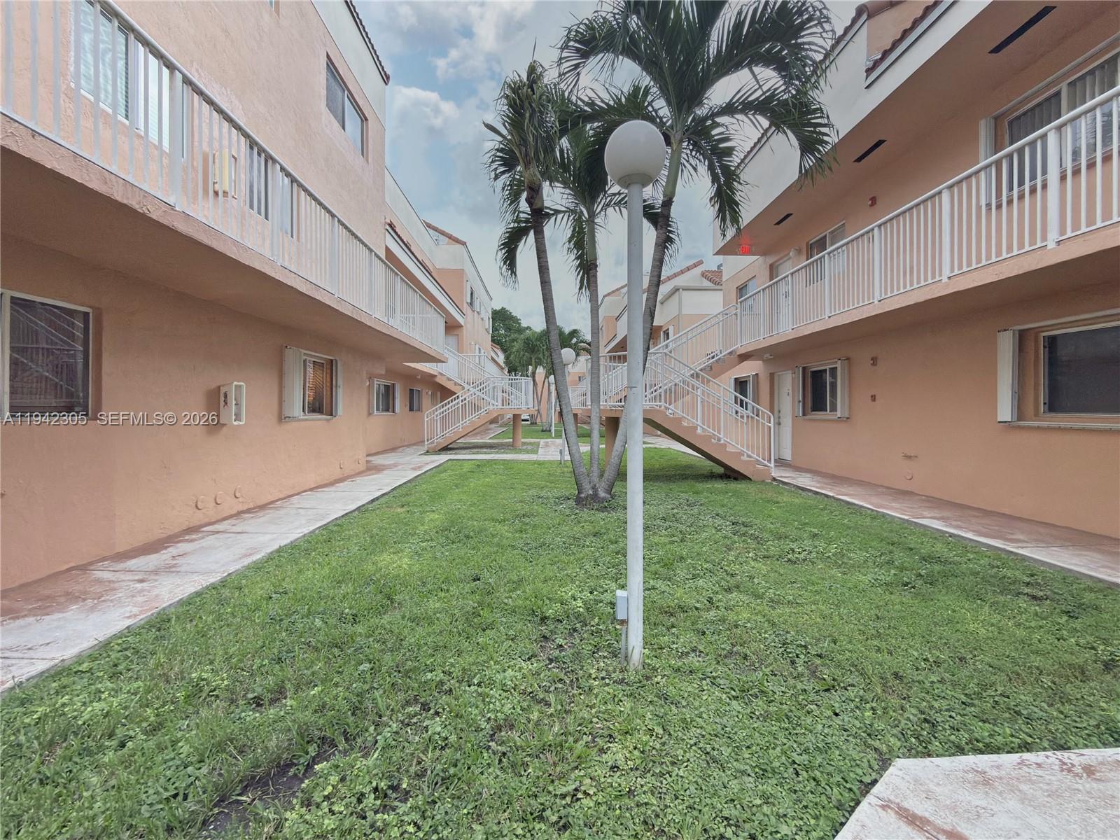 14911 Southwest 80th Street, Unit 221 Miami, FL 33193 - Photo 8 of 31 a view of a house with a backyard