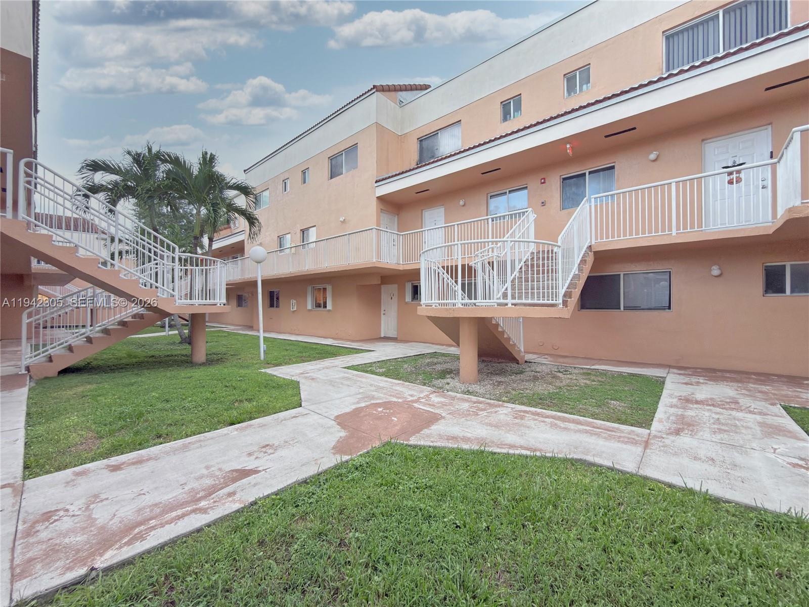 14911 Southwest 80th Street, Unit 221 Miami, FL 33193 - Photo 10 of 31 a view of a building with a yard