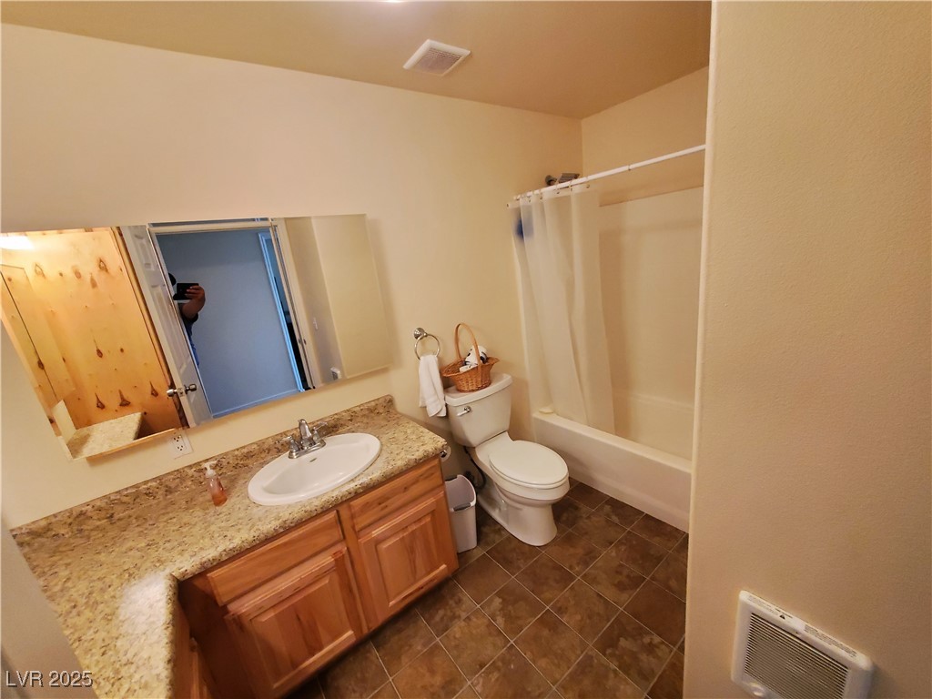 5272 Truman Lane Caliente, NV 89008 - Photo 9 of 39 Bathroom featuring vanity, toilet, and shower / tub combo with curtain