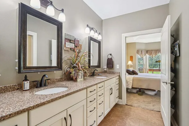 a en suite bathroom with sinks double vanity and a mirror