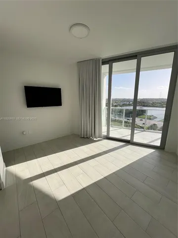 a view of walk in closet with natural light