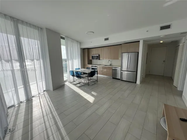 a view of an empty room and a window