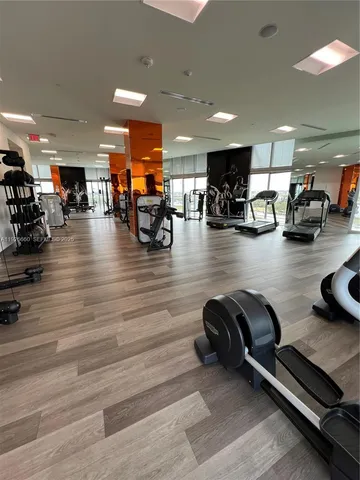 a view of a room with gym equipment and a table