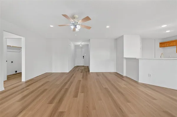 a view of empty room with wooden floor