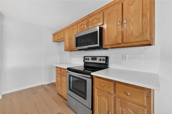 a kitchen with stainless steel appliances granite countertop a stove microwave and oven