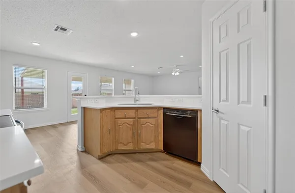a bathroom with a granite countertop sink mirror and cabinets