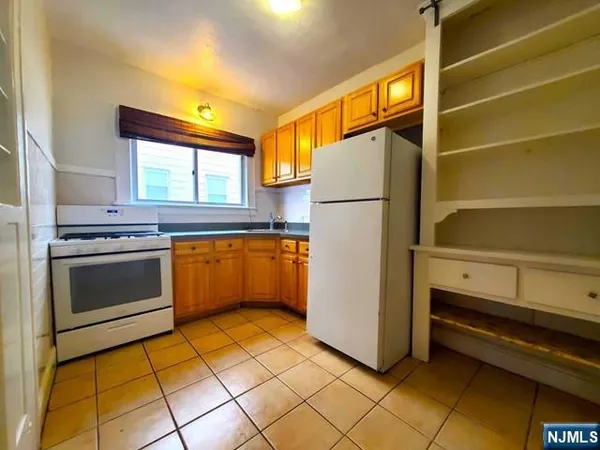 a kitchen with a stove and a refrigerator