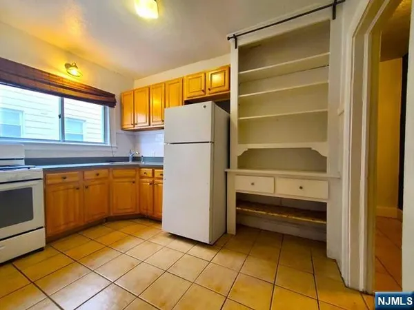 a kitchen with a refrigerator and a stove