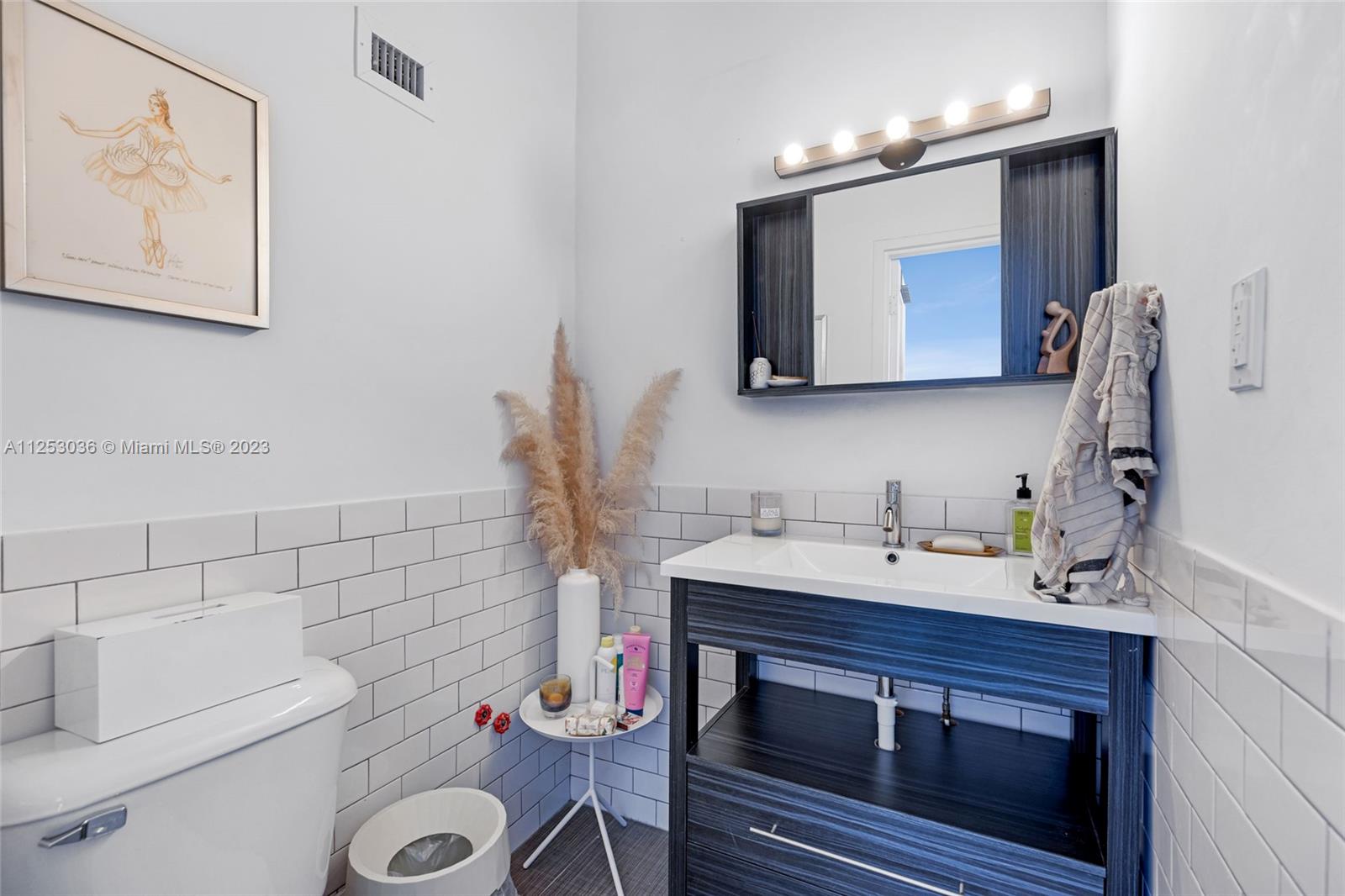 a bathroom with a sink vanity and toilet