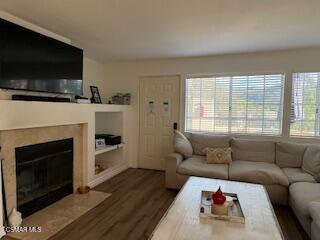 a living room with furniture a flat screen tv and a fireplace