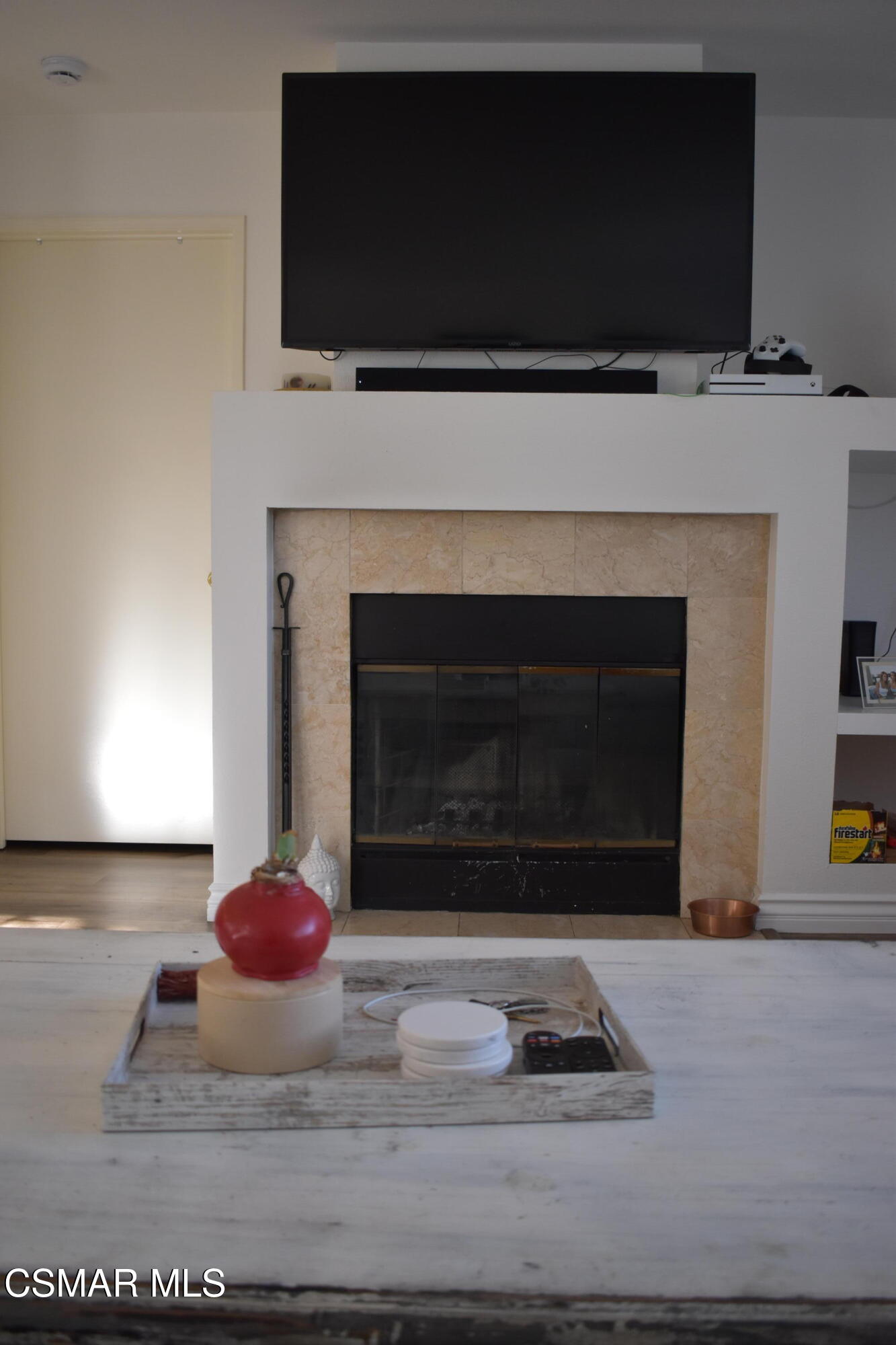 4240 Lost Hills Road, Unit 2901 Calabasas, CA 91301 - Photo 3 of 15 a living room with a fireplace and a flat screen tv
