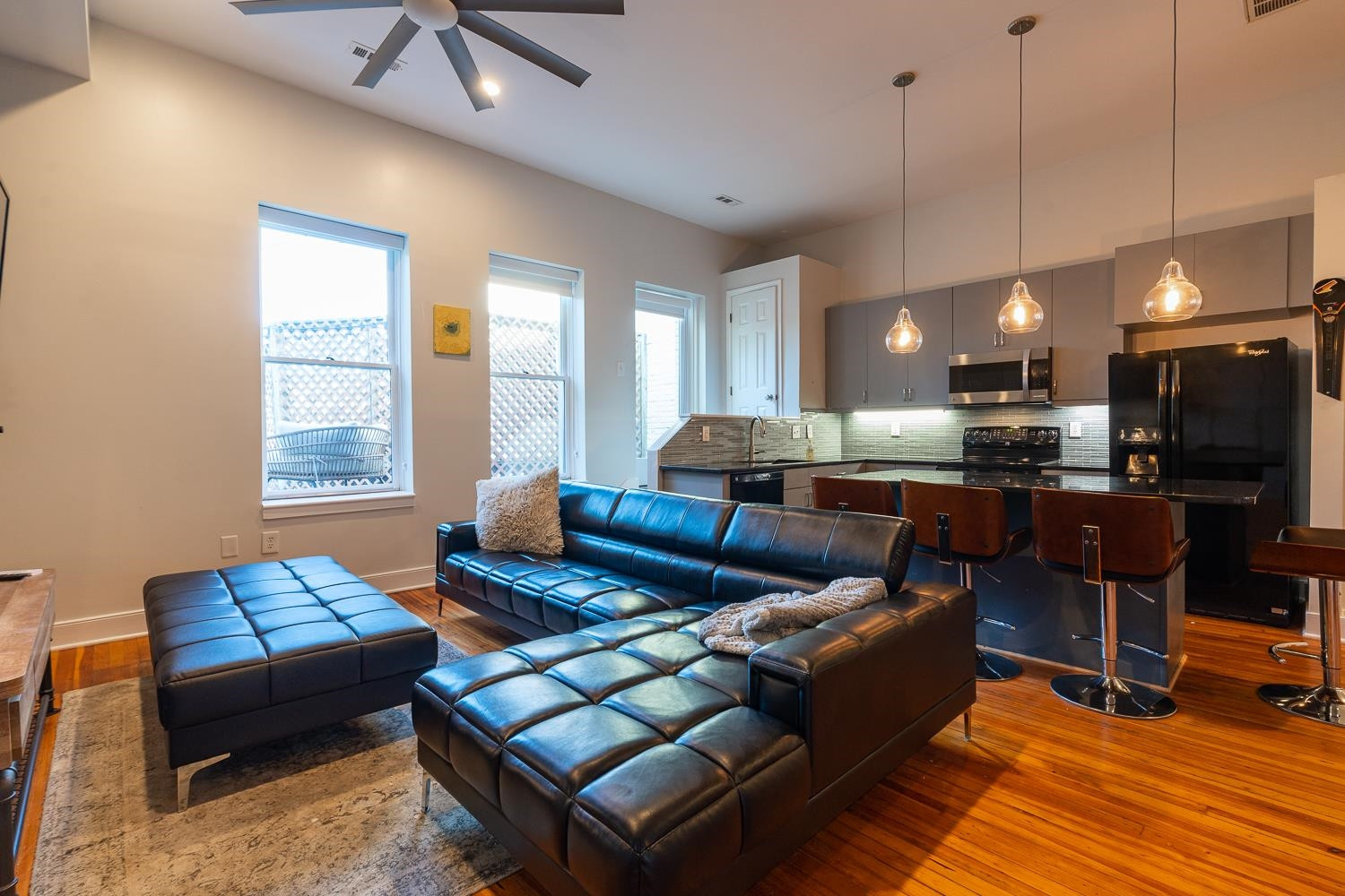 323 West Main Street, Unit B Durham, NC 27701 - Photo 3 of 14 a living room with furniture a wooden floor and kitchen view