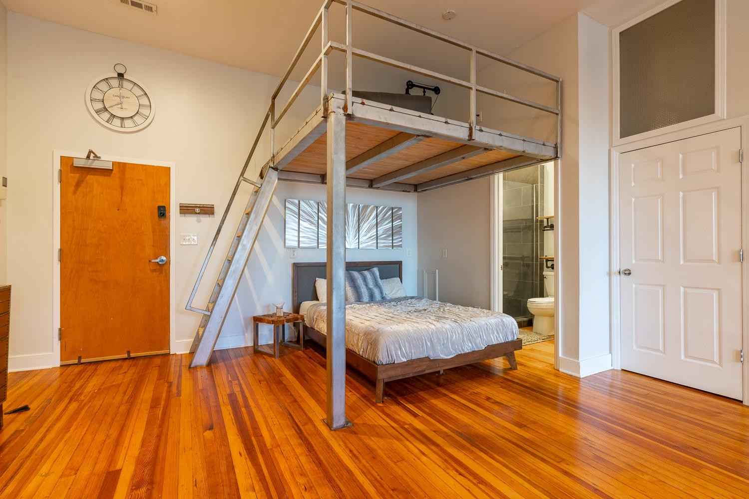 323 West Main Street, Unit B Durham, NC 27701 - Photo 7 of 14 a bedroom with wooden floor and a bed