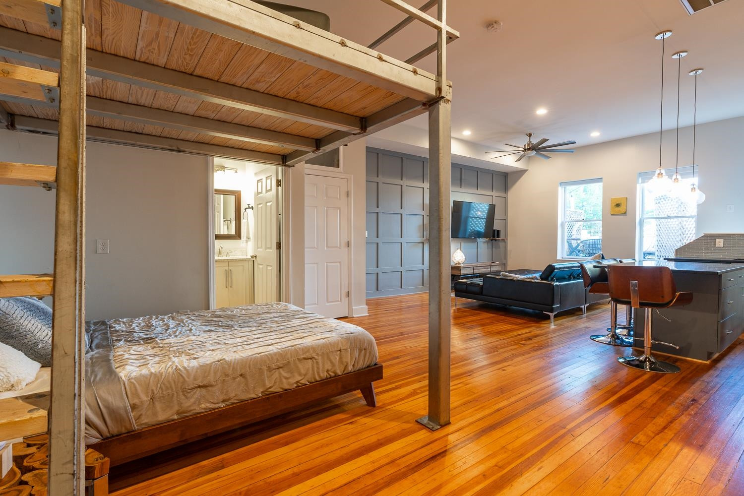 323 West Main Street, Unit B Durham, NC 27701 - Photo 8 of 14 a bedroom with a bed a table chair and wooden floor