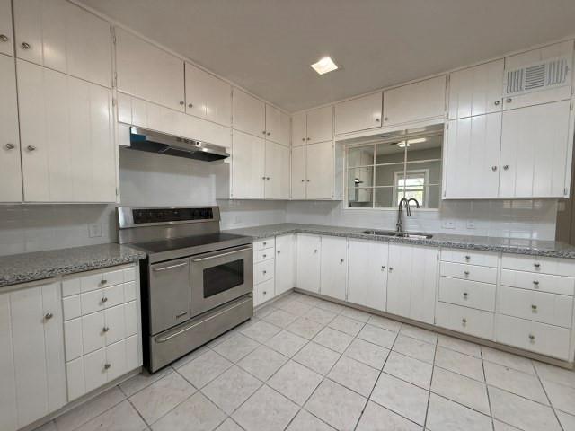 1001 North 3rd Street Lamesa, TX 79331 - Photo 8 of 32 a kitchen with cabinets appliances and a sink