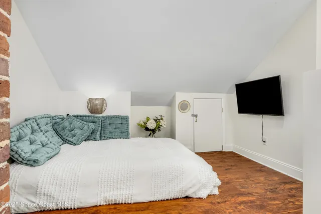 a bedroom with a bed and a flat screen tv