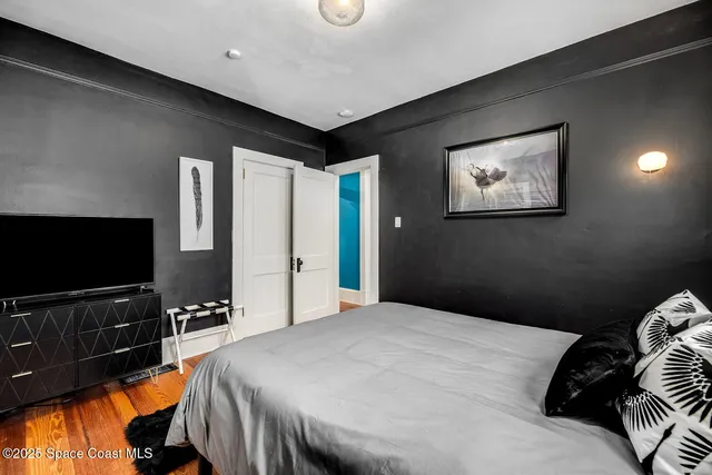 a bedroom with a bed flowerpot and a window