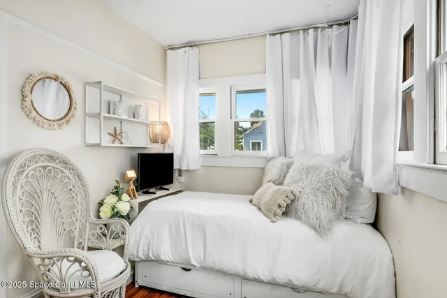 a living room with furniture and a mirror