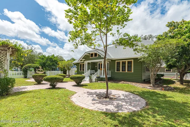 a front view of a house with a garden