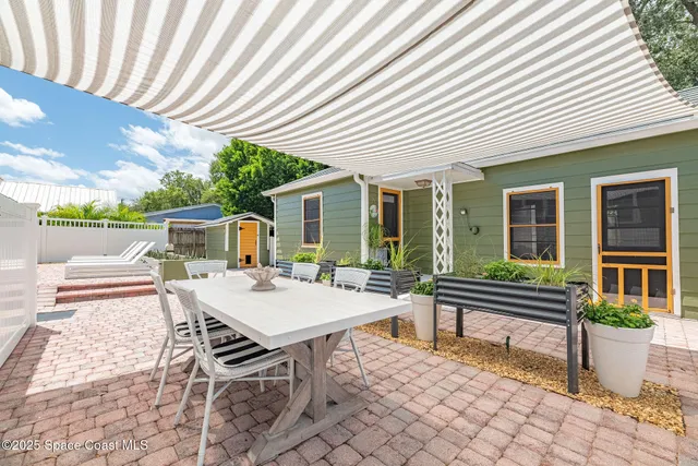 a table and chairs in front of a house