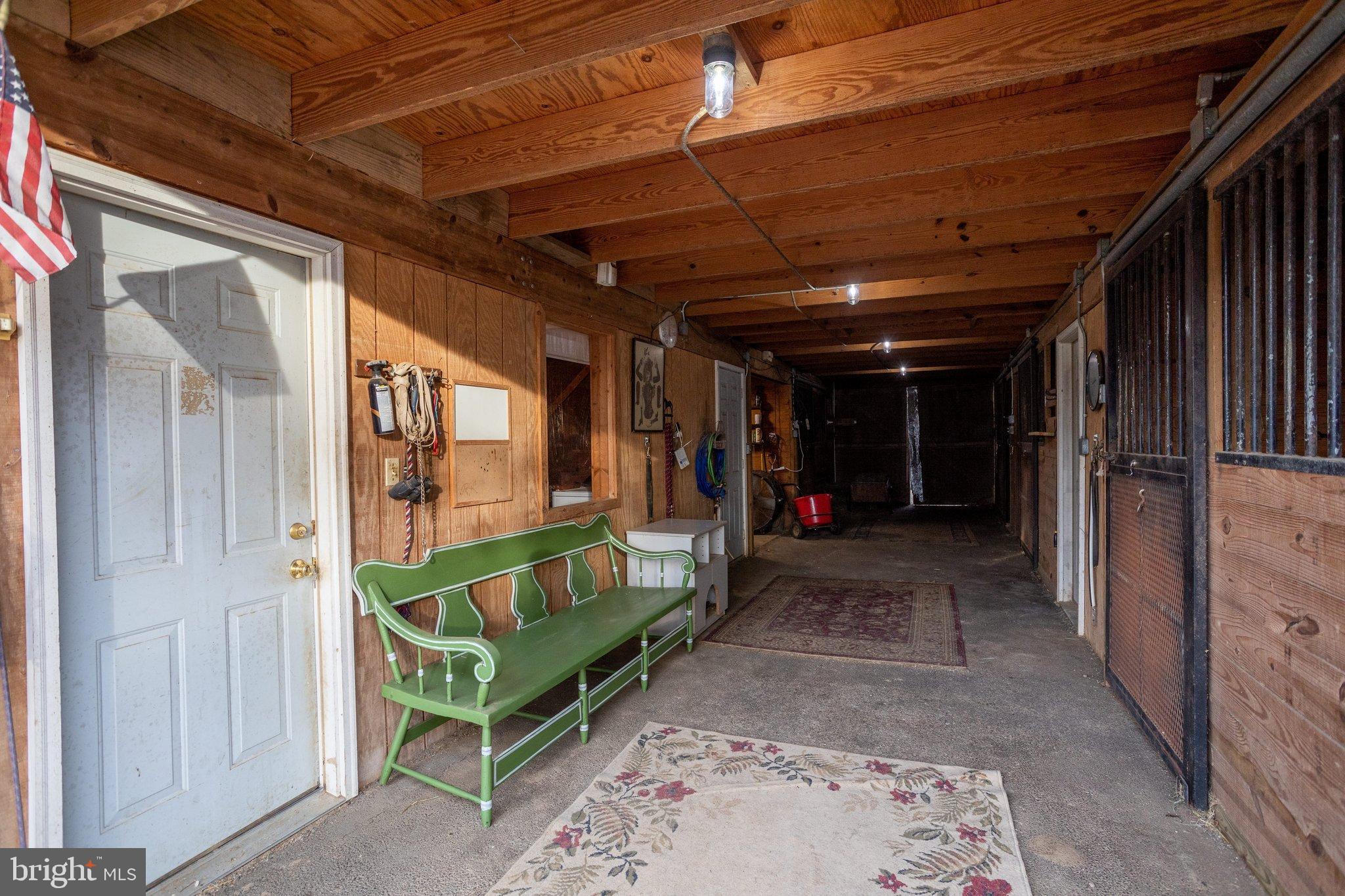 17207 Hunter Green Road Upperco, MD 21155 - Photo 40 of 56 Aisle as you enter the barn. Tack rm door on left