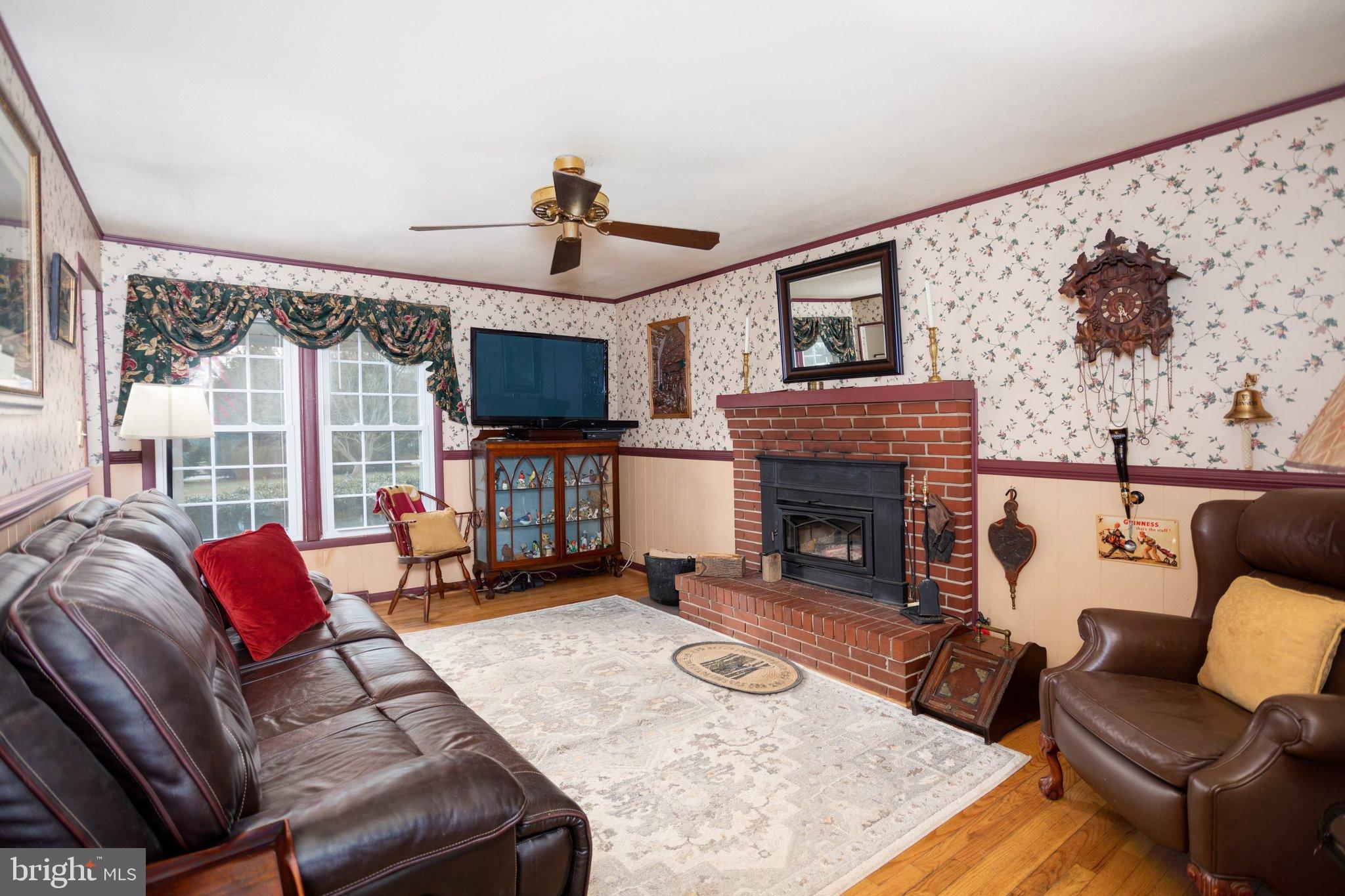 17207 Hunter Green Road Upperco, MD 21155 - Photo 9 of 56 Family Room w/ wood stove/Chair and Crown moldings