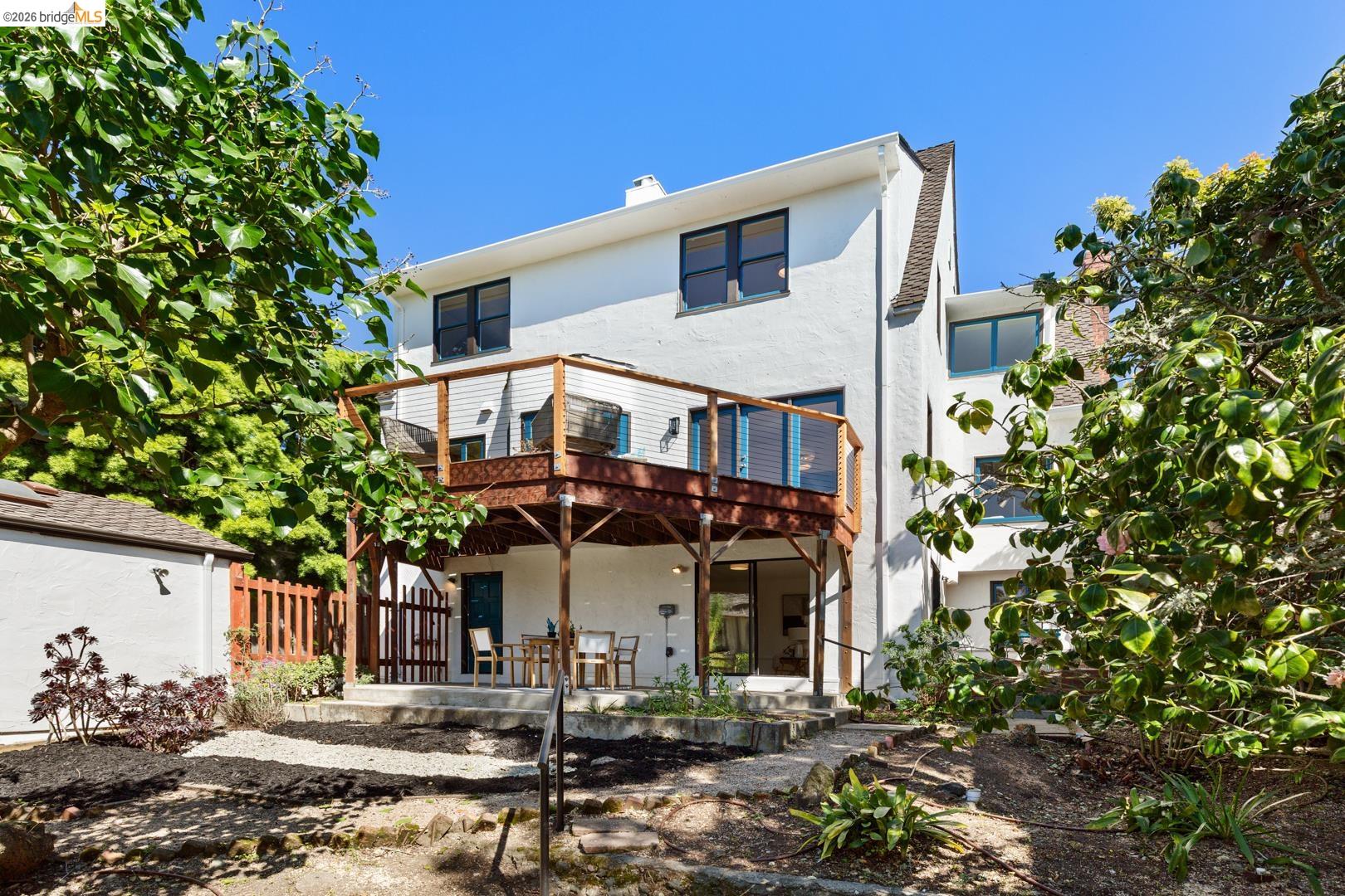 758 Spruce Street Berkeley, CA 94707 - Photo 40 of 60 Rear view of property with stucco siding, a chimney, and a wooden deck