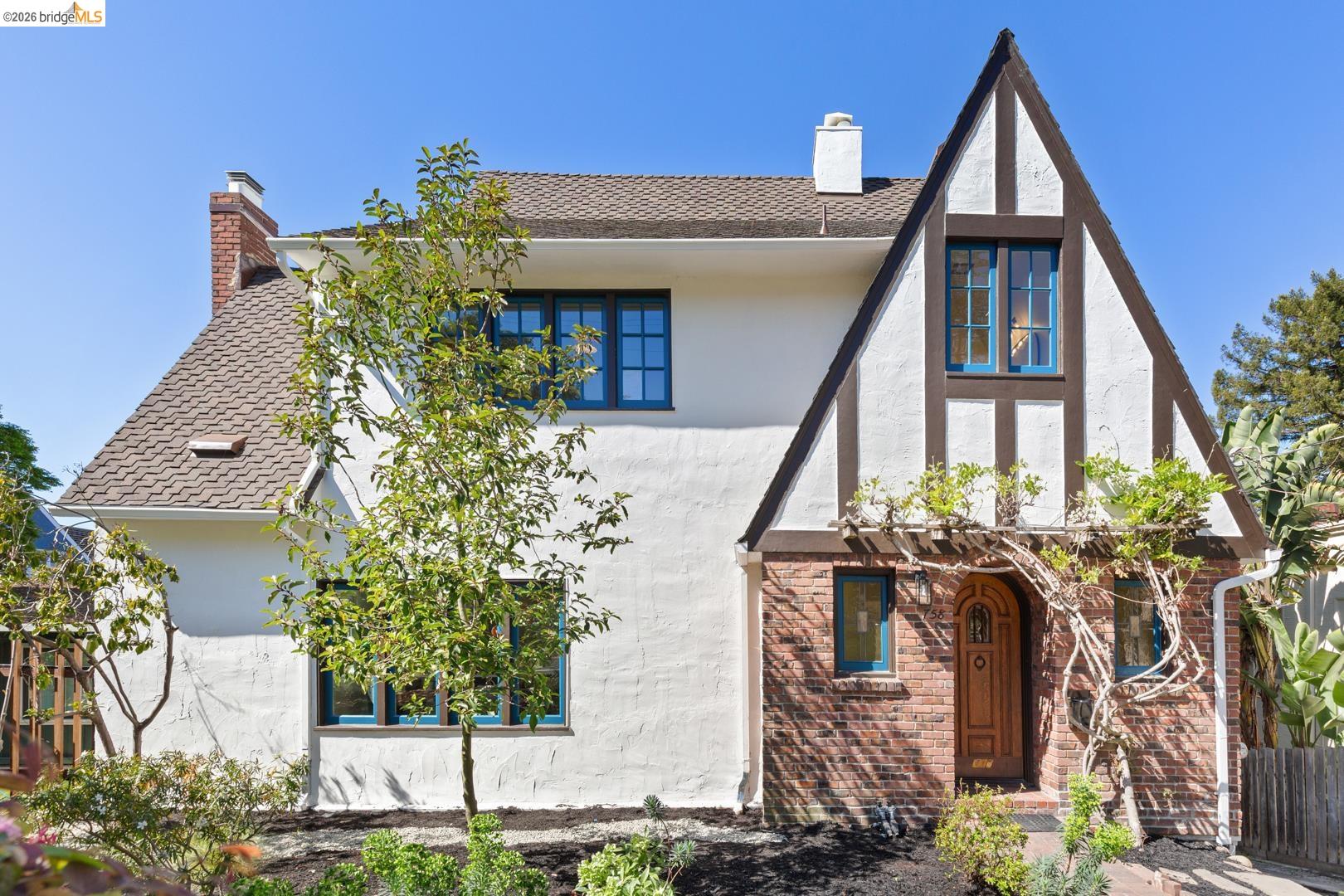 758 Spruce Street Berkeley, CA 94707 - Photo 49 of 60 View of front facade with a chimney, stucco siding, and brick siding