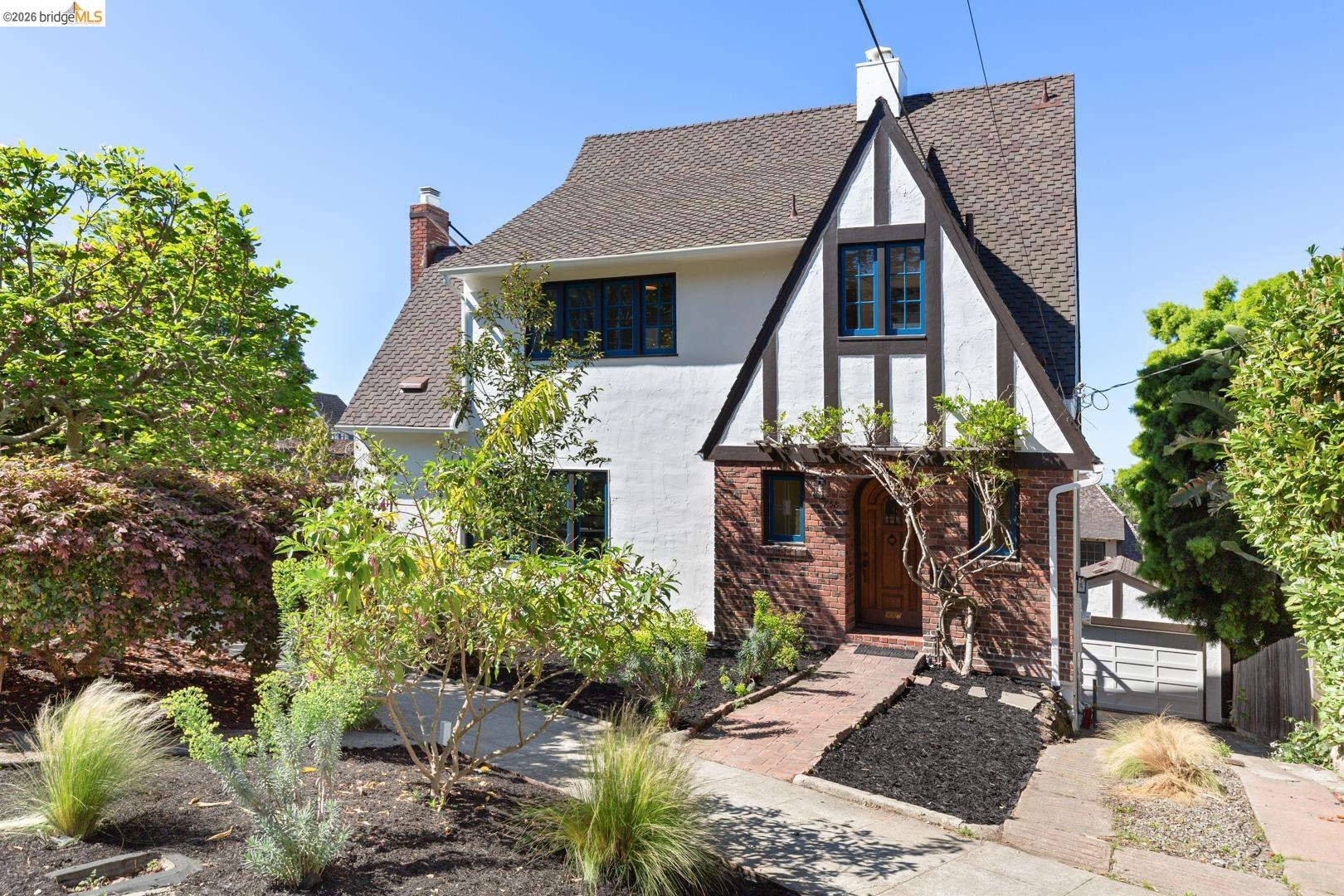 758 Spruce Street Berkeley, CA 94707 - Photo 51 of 60 View of front of property featuring stucco siding, a chimney, a shingled roof, an outdoor structure, and brick siding