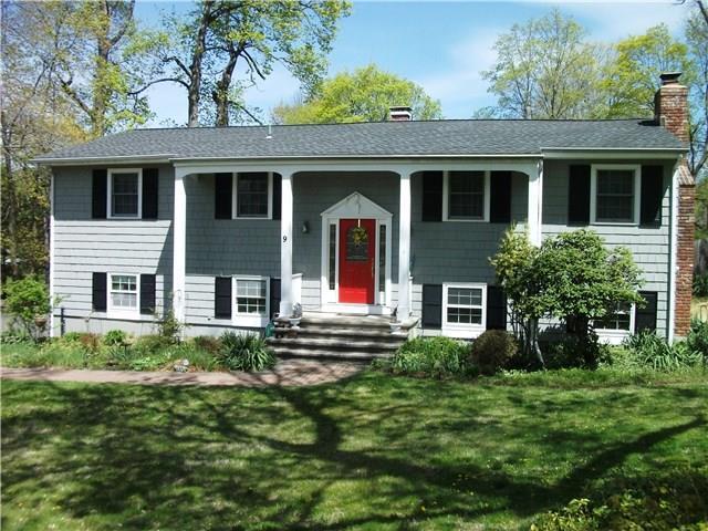 9 Stonecrest Road Ridgefield, CT 06877 - Photo 1 of 1 a front view of a house with a yard