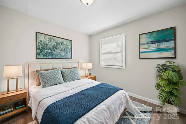 a bedroom with a bed and a painting on the wall