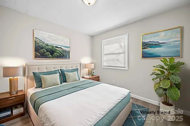 a bedroom with bed and wooden floor