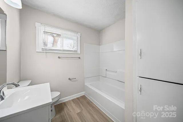 a white bath tub sitting next to a white sink