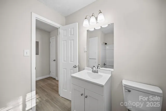 a bathroom with a sink mirror and vanity