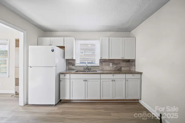 a white refrigerator freezer sitting inside of a kitchen