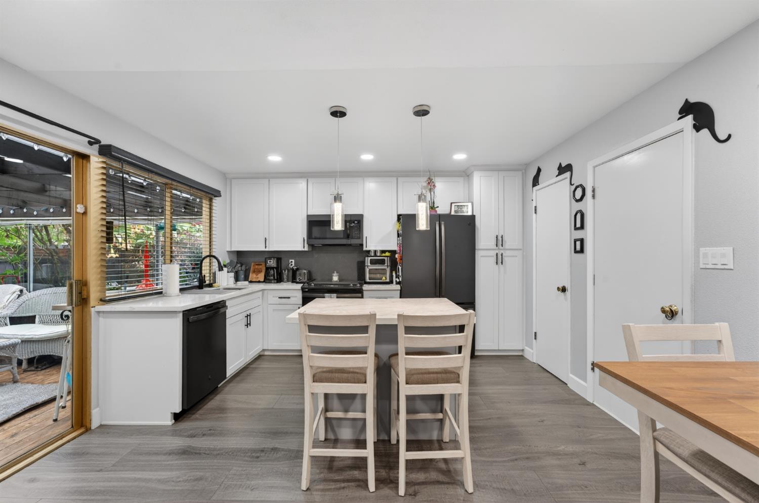 4625 Ruth Way Union City, CA 94587 - Photo 15 of 60 a kitchen with stainless steel appliances kitchen island granite countertop a refrigerator a stove a sink a dining table and chairs with wooden floor